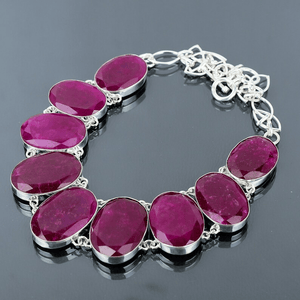 Silver bracelet with pink gemstones on a dark background