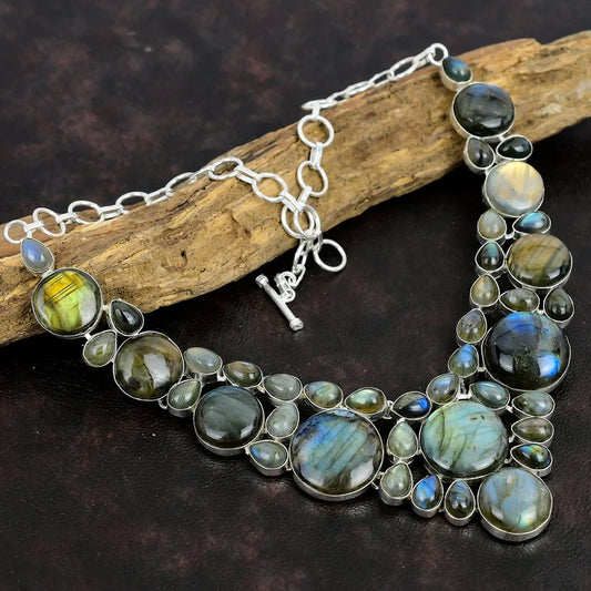 Necklace with Labradorite stones on a dark surface with wood