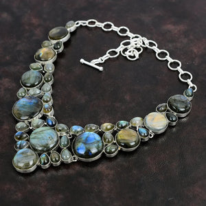 Necklace with Labradorite stones on a dark brown background