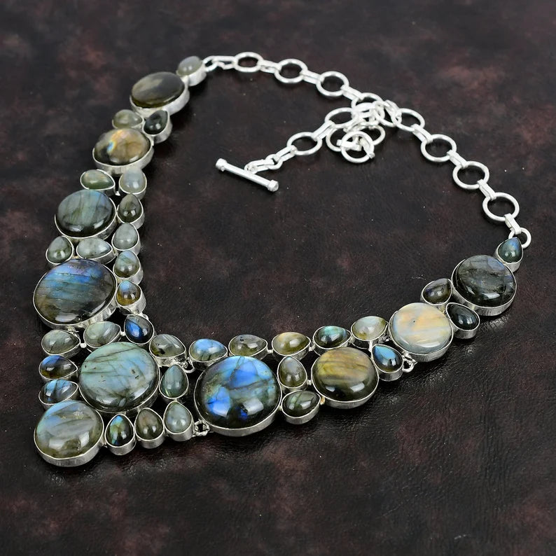 Necklace with Labradorite stones on a dark brown background