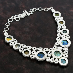 Silver necklace with circular pendants on a dark background