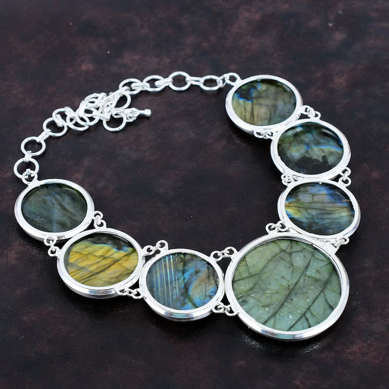 Silver bracelet with labradorite stones on a dark background