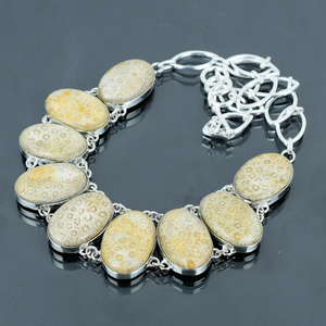 Necklace with stone-encrusted chain on a dark background