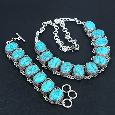 Turquoise necklace and bracelet set on a dark background