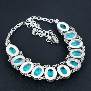 Silver necklace with turquoise stones on a black background