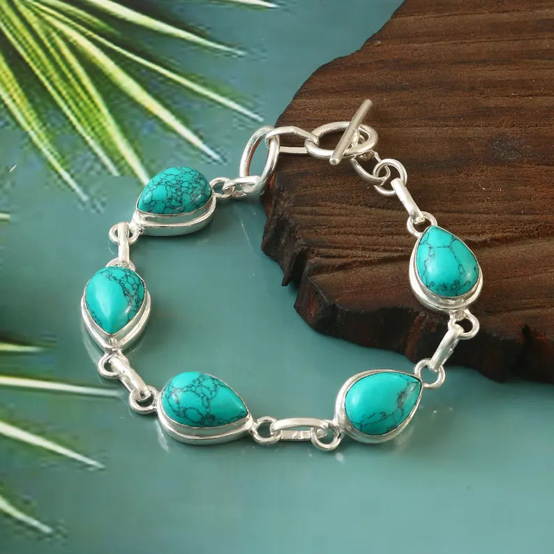 Turquoise bracelet with silver links on a natural background